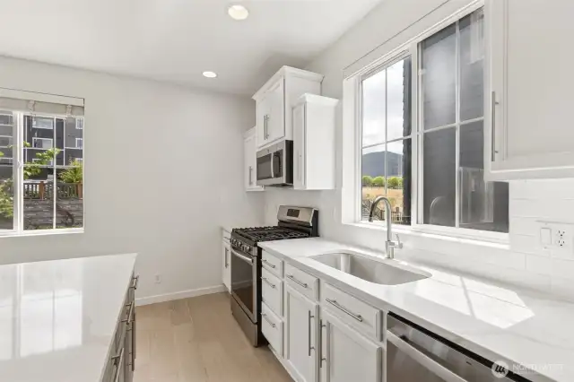 Beautifully updated kitchen with sleek new counters, a spacious undermount sink, and an abundance of natural light pouring in through multiple windows. Bright, functional, and designed for both style & flow.