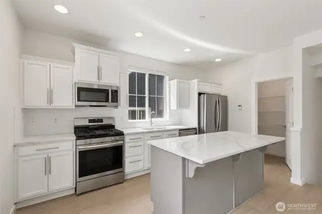 Updated kitchen boasts a central island for prep & seating, plus a large walk-in pantry for ample storage—combining function, style, and everyday convenience in one beautiful space.
