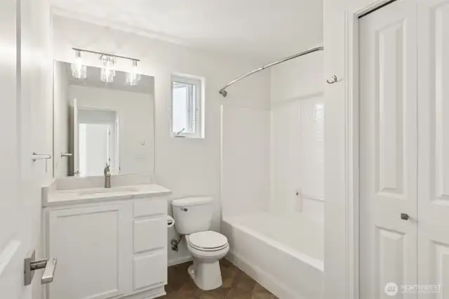 Well-appointed full bathroom with sleek finishes and built-in storage—combining everyday function with clean, modern style.