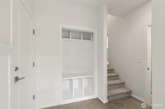 Welcoming main-level entry features a custom board & batten accent wall, ideal for future hooks, and a built-in bench with storage—perfect for keeping shoes and daily items neatly tucked away.