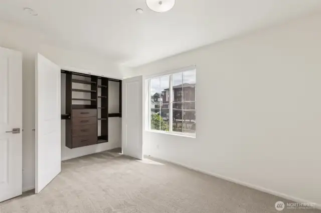 Custom built-in closet system in the primary suite offers smart storage with a clean, organized layout—combining function and luxury for everyday ease.