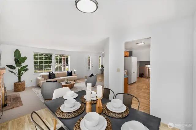 View across dining room, looking back toward entry and into the kitchen. There is a comfortable layout and flow to this house.