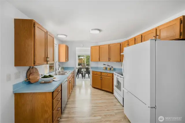 View of the kitchen and beyond, into the dining room.