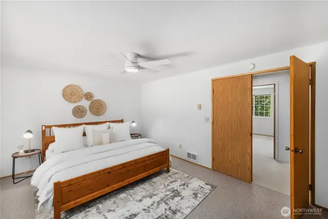Primary bedroom on upper level, features double doors and ample space for a king-size bed.