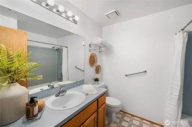 Full bathroom on upper level landing, beside other bedrooms.