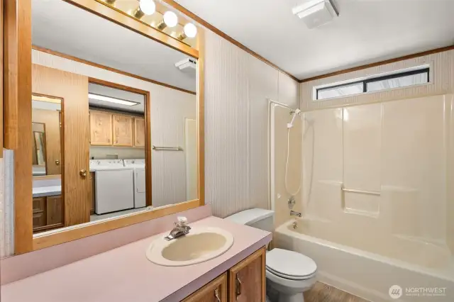 Hall bath has 2 doors: 1 from the hallway & 1 from the utility room.