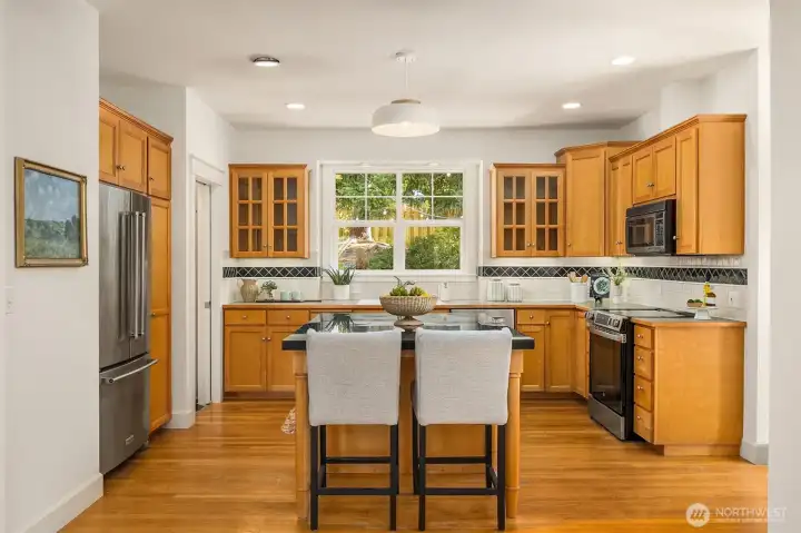 The kitchen with breakfast counter and plenty of storage.