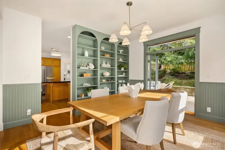 The dining room with recently built custom shelves an added wainscoting.