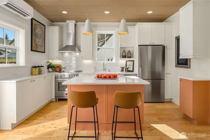 Efficient kitchen features Bertazzoni induction cooking, 600 CFM hood, refrigerator and Bosch dishwasher. Custom Bellmont painted cabinetry with pull out pantry cabinets.