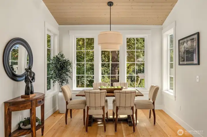A stunning large dining room overlooks the woodland and creek beyond.