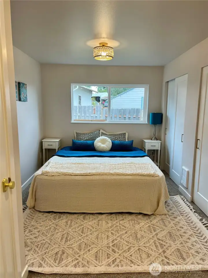 Primary with closet on left and wall of closets on the right