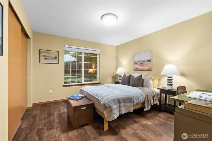 At the end of the hallway, a spacious bedroom offers comfort and quiet retreat.