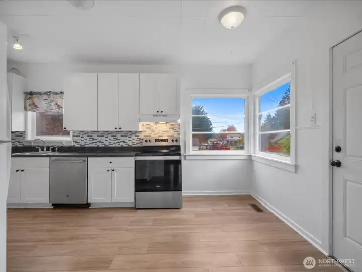 Eating space at corner windows and door to the deck.