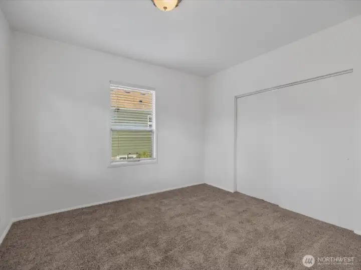 Main floor bedroom with big closets. Each of the two bedrooms on this level has new carpeting.