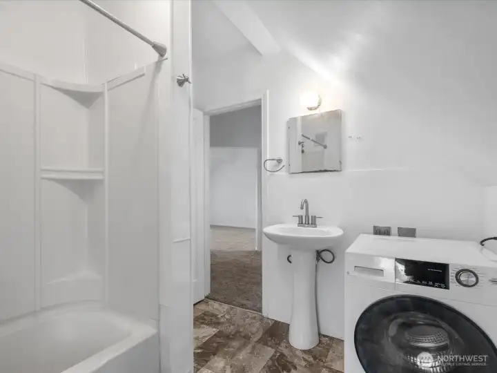 Upper level full bath with its washer/dryer.