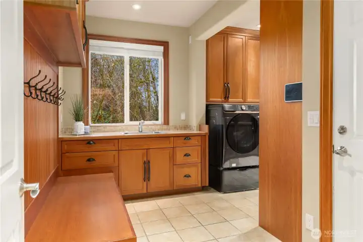 The main floor 'mud room' and laundry is the 'workhorse' of this home. Floor to ceiling cabinets galore, and cubbies and hooks for all.