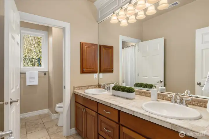 Upper floor full bath with double vanities.