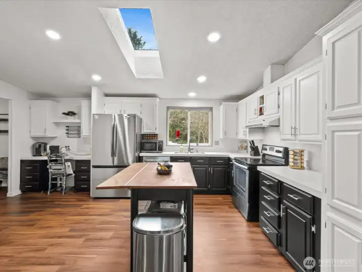 Abundant beautifully painted cabinetry with new hardware.