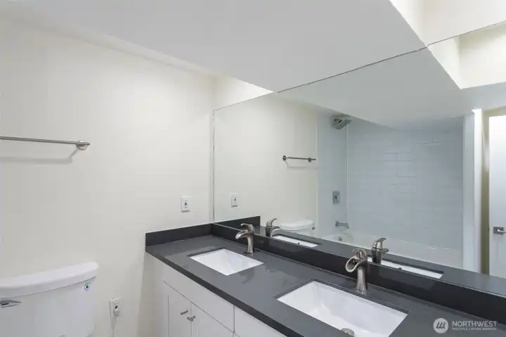 Lower level suit offers full bathroom with a double vanity.