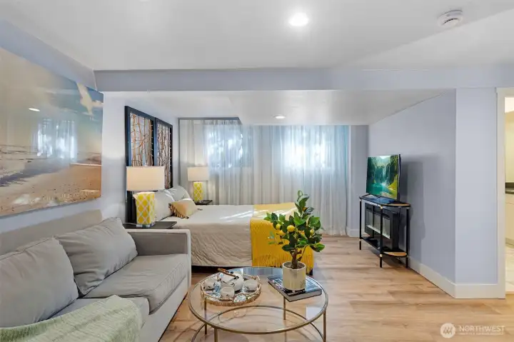 This primary suite is a sprawling daylight basement retreat that defies the traditional "bedroom" label, functioning instead as a private, high-end wing of the home.