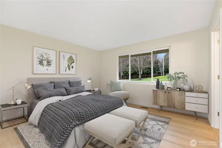Spacious primary suite overlooks the back yard