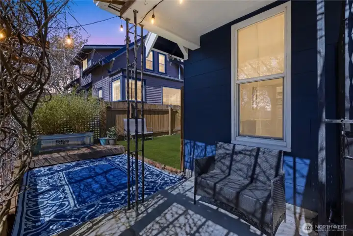 Enjoy the spring sunset or sunshine on your front patio, filtered through the hundred year old wisteria