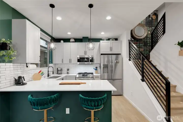 Excellent kitchen with room for breakfast bar seating. A large quartz covered island makes for easy entertaining as well.