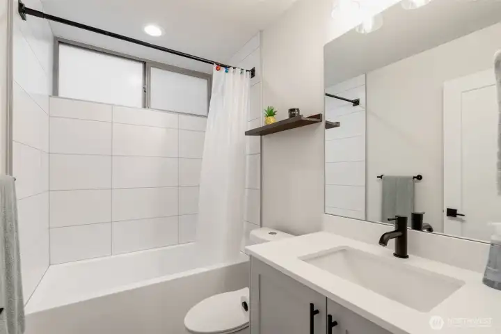 Guest bathroom on the middle floor has a deep soaking tub.