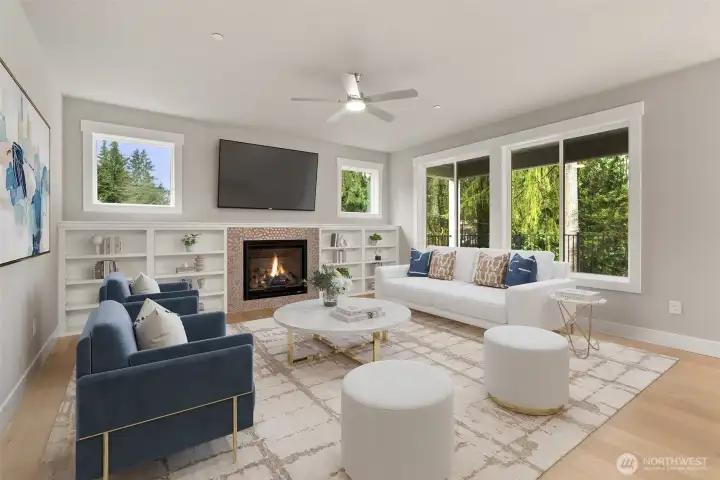 Wood wrapped windows, hardwood floors, ceiling fan and cozy gas fireplace. Shelving is shown for decor purposes only as part of virtual staging.