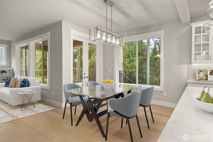 Dining Room w/ hardwood floors, stunning chandelier and access to fenced back yard.