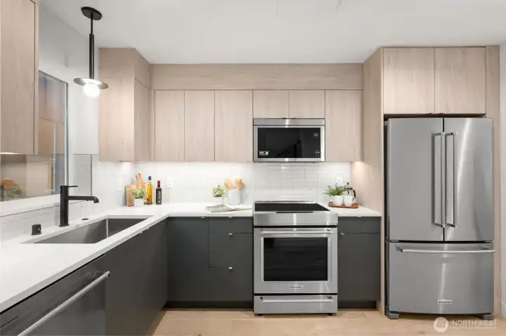 : Modern cabinetry and designer hardware provide ample storage and high-end style.