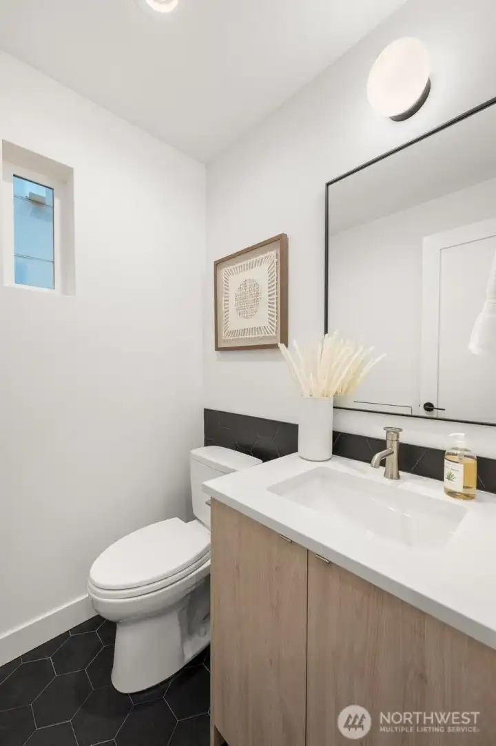 Modern powder room featuring a floating vanity and minimalist designer fixtures.