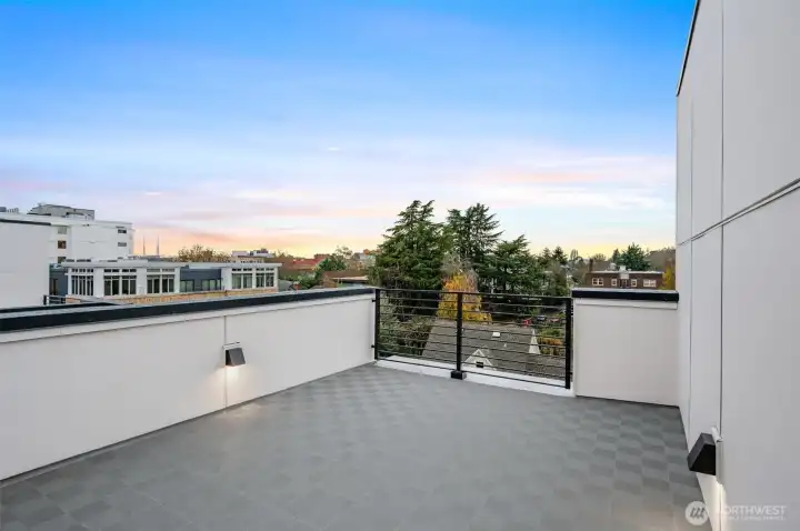 a private roof deck with sweeping 180-degree views of the city and mountains.