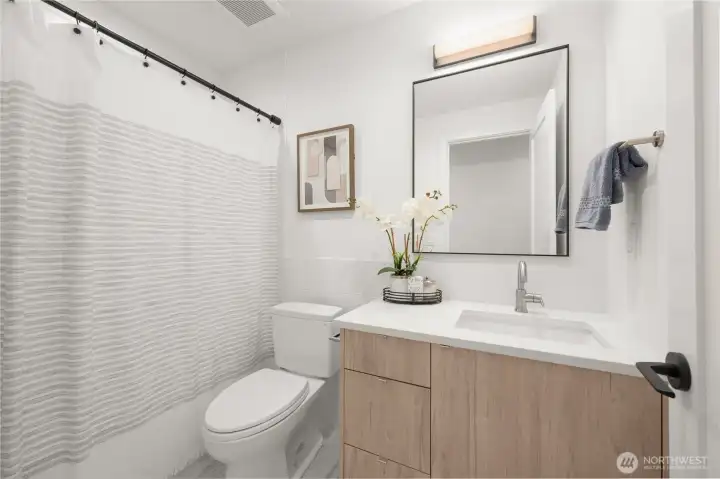 Full secondary bathroom with a contemporary vanity and designer lighting
