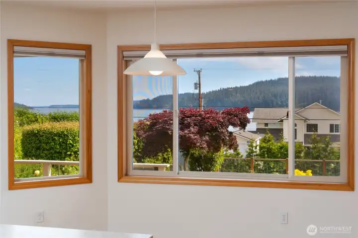 Large windows frame serene water and hillside views. Large windows frame serene water and hillside views.