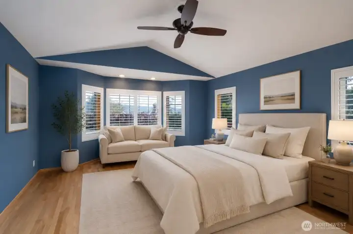 Spacious primary suite with vaulted ceilings and rich blue accents. Spacious primary suite with vaulted ceilings and rich blue accents.