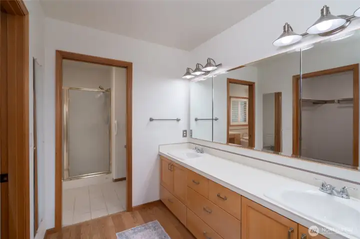 Primary bath with dual vanity, walk-in shower, and ample storage. Primary bath with dual vanity, walk-in shower, and ample storage.