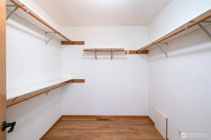 Large walk-in closet with built-in shelving and abundant storage. Large walk-in closet with built-in shelving and abundant storage.