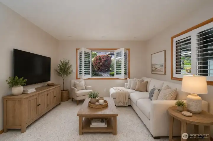 Cozy lower-level lounge with garden views and abundant natural light. Cozy lower-level lounge with garden views and abundant natural light.