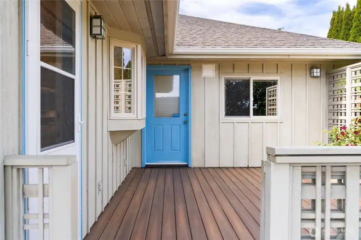 Private deck entrance with charming blue door and low-maintenance design. Private deck entrance with charming blue door and low-maintenance design.