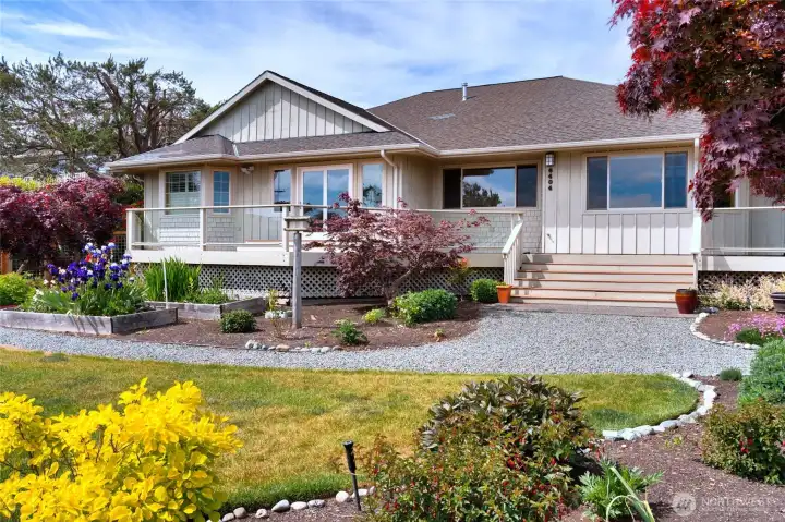 Beautifully landscaped home with expansive decks and inviting curb appeal. Beautifully landscaped home with expansive decks and inviting curb appeal.