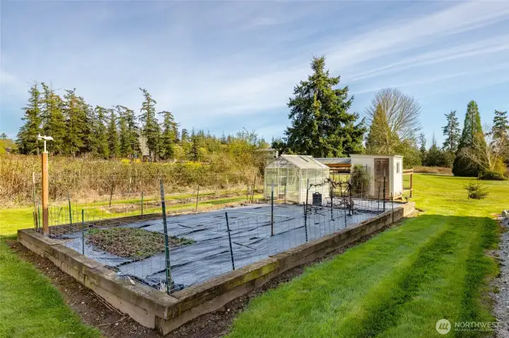 Raised garden beds and a chicken coop.