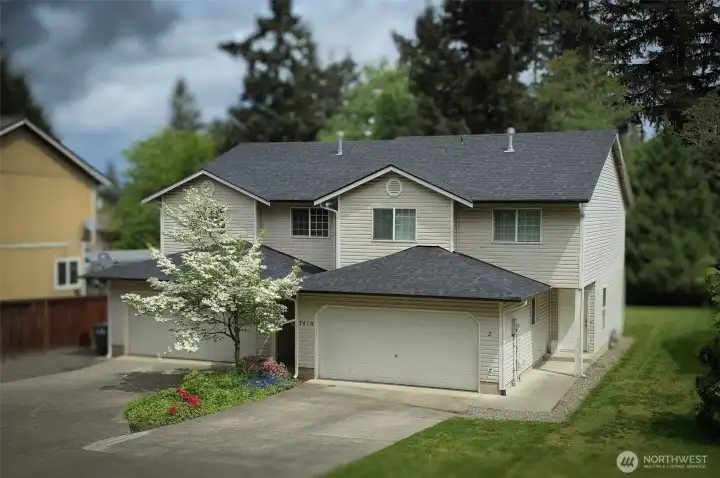 Spacious duplex with side-by-side two-story design, attached garages, and a peaceful setting surrounded by mature trees. Convenient driveway parking, private entrances, and a welcoming residential feel create strong owner-occupant or investment appeal.