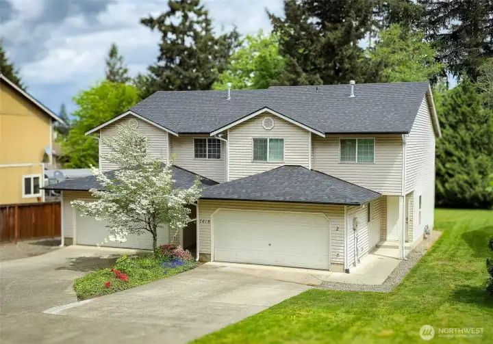 Spacious duplex with side-by-side two-story design, attached garages, and a peaceful setting surrounded by mature trees. Convenient driveway parking, private entrances, and a welcoming residential feel create strong owner-occupant or investment appeal.