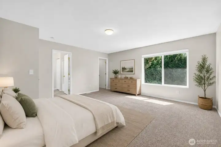 Expansive primary suite offers exceptional space, oversized windows with peaceful greenery views, and room for additional seating or workspace. Large layout creates a true retreat feel while maintaining a bright, open atmosphere.