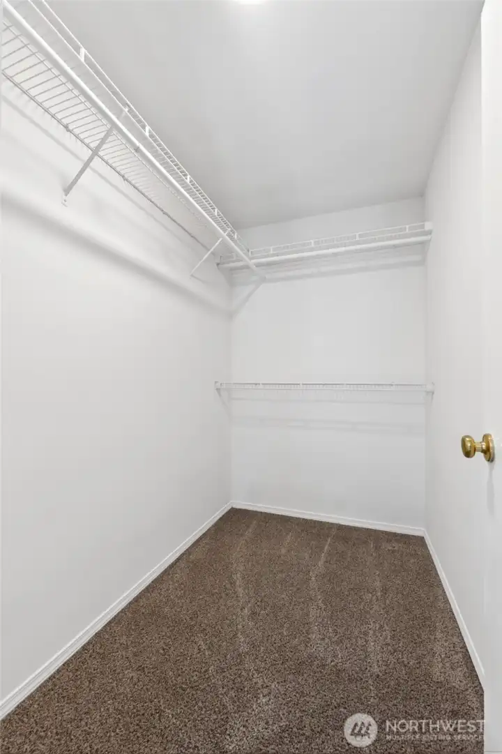 Large walk-in closet in the primary suite provides abundant hanging and storage space with built-in shelving and room for seasonal organization. Generous layout adds everyday convenience and enhances the functionality of the primary retreat.