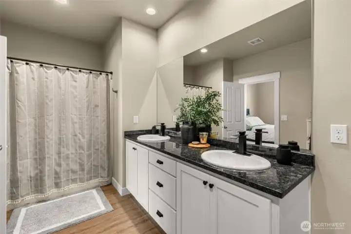 Primary Bath with dual sink basins and tub/shower combo