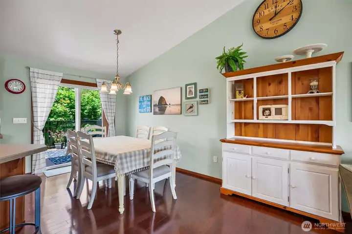 Spacious dining area with vaulted ceiling and access to deck