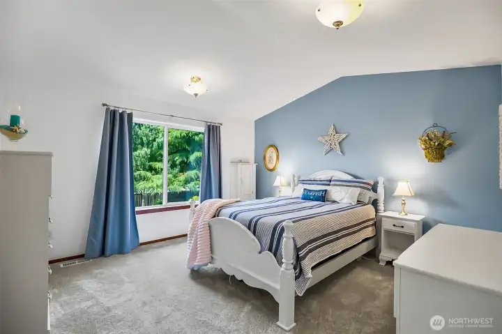 Spacious primary retreat with vaulted ceiling.
