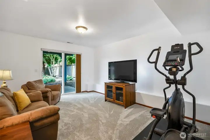 Family room, great place for movie night, slider to back private fenced back yard retreat.